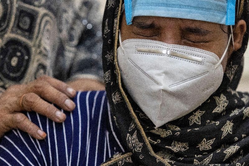 Huma cries as she waits to speak with her grandmother Salma, a coronavirus disease (COVID-19) patient, using a video calling facility provided by the authorities to connect with COVID-19 patients at the LNJP hospital, in New Delhi India.  (Photo by Danish Siddiqui/Reuters)